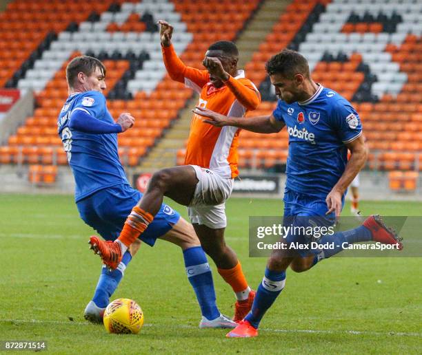 Blackpool's Viv Solomon-Otabor runs at /Portsmouth's Oliver Hawkins and Gareth Evans during the Sky Bet League One match between Blackpool and Wigan...