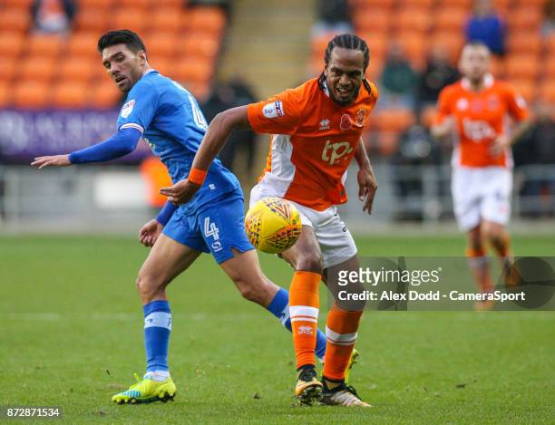 Blackpool's Nathan Delfouneso battles with Portsmouth's Danny Rose during the Sky Bet League One match between Blackpool and Wigan Athletic at...