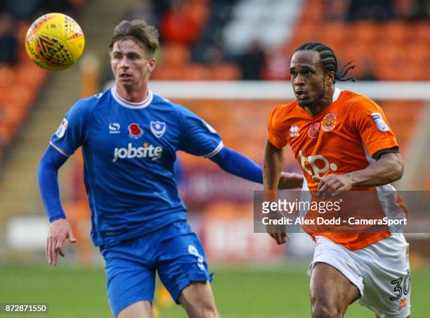 Blackpool's Nathan Delfouneso chases a ball under pressure from Portsmouth's Oliver Hawkins during the Sky Bet League One match between Blackpool and...