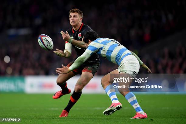 Henry Slade of England looks to offload as he is tackled during the Old Mutual Wealth Series match between England and Argentina at Twickenham...