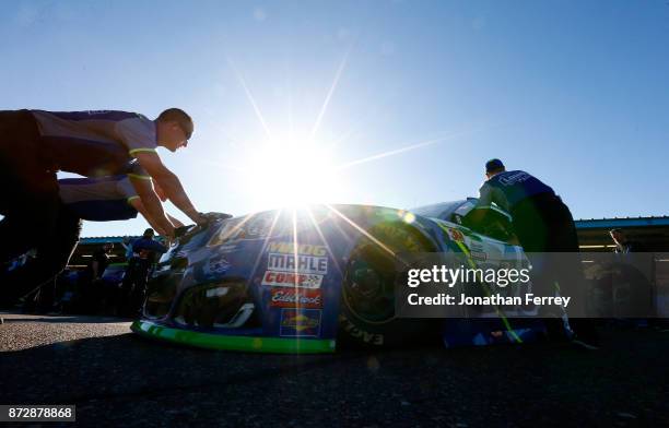 Crew members of Jimmie Johnson, driver of the Lowe's Chevrolet, push the car during practice for the Monster Energy NASCAR Cup Series Can-Am 500 at...