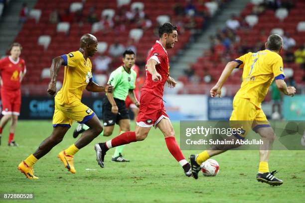 Albert Riera of Liverpool Masters dribbles Luis Boa Morte of Arsenal Masters during the Battle of the Masters at National Stadium on November 11,...
