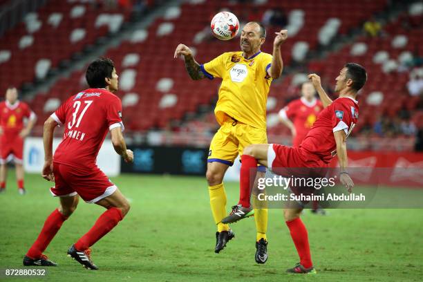 Luis Garcia of Liverpool Masters challenges David Hillier of Arsenal Masters as Jari Litmanen of Liverpool Masters looks on during the Battle of the...