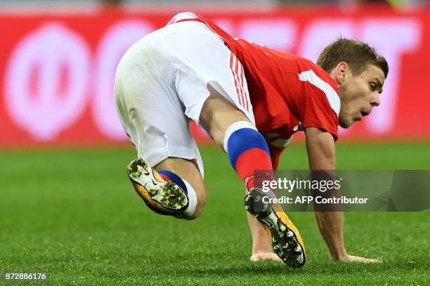 Russia's forward Alexander Kokorin falls during an international friendly football match between Russia and Argentina at the Luzhniki stadium in...