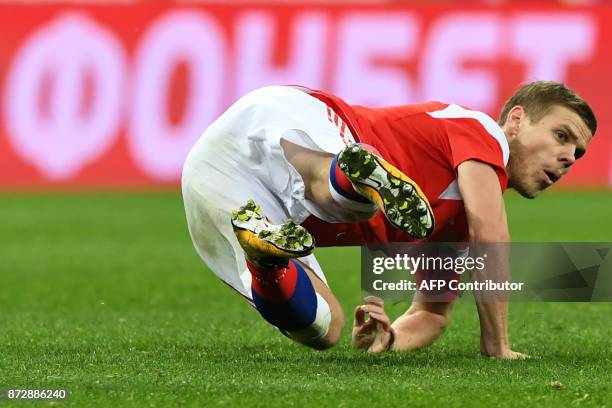 Russia's forward Alexander Kokorin falls during an international friendly football match between Russia and Argentina at the Luzhniki stadium in...