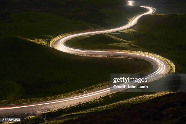 mountain road at night. long exposure. - derbyshire stock-fotos und bilder