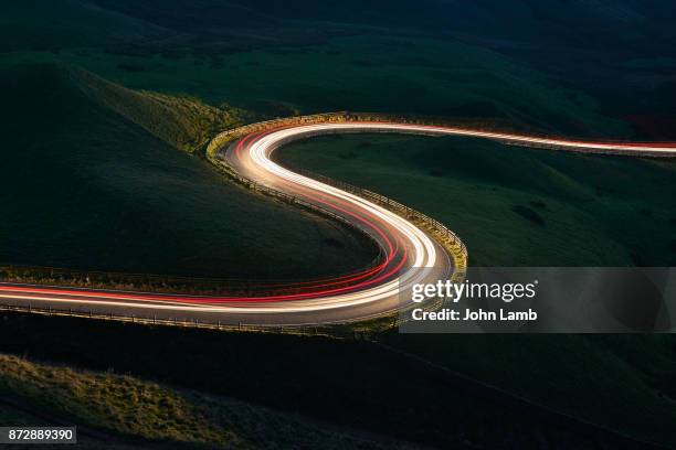 mountain road at night.long exposure. - derbyshire stock-fotos und bilder