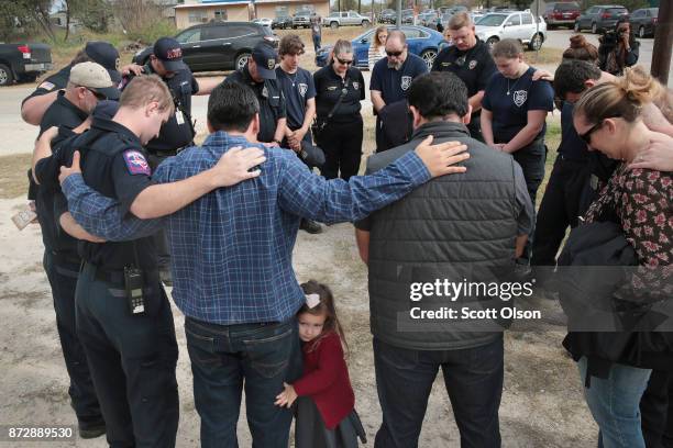 First responders share a prayer following a Veterans Day ceremony outside the Community Center on November 11, 2017 in Sutherland Springs, Texas. The...