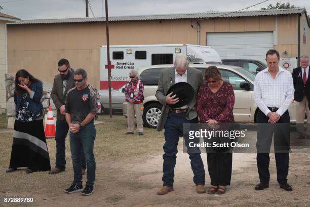 Residents and visitors share a prayer during a Veterans Day ceremony outside the Community Center on November 11, 2017 in Sutherland Springs, Texas....