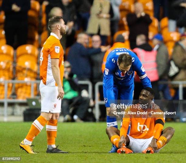 Portsmouth's Brett Pitman tries to console Blackpool's Viv Solomon-Otabor after the final whistle during the Sky Bet League One match between...