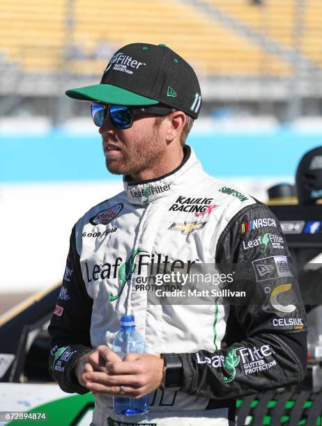 Blake Koch, driver of the LeafFilter Gutter Protection Chevrolet, stands by his car during qualifying for the NASCAR Xfinity series Ticket Galaxy 200...