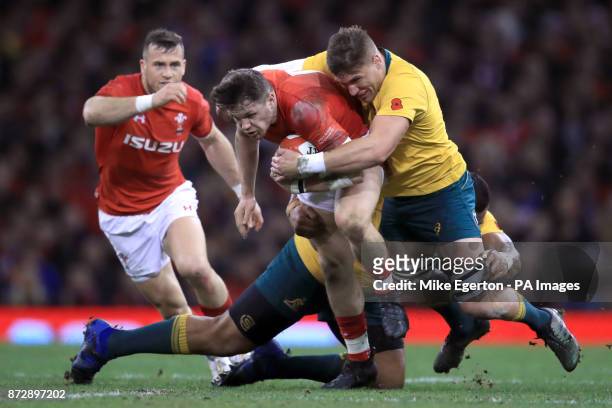 Wales' Steffan Evans is tackled by Australia's Tevita Kuridrani and Sean McMahon during the Autumn International at the Principality Stadium, Cardiff.