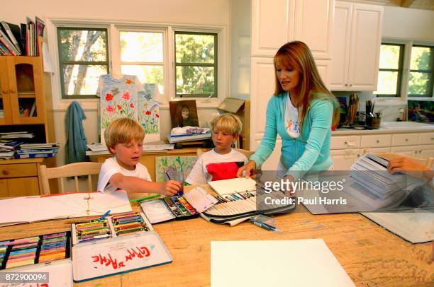 Actress and artist Jane Seymour stands in her art studio and dressing room with her twin sons John and Christopher at her home overlooking the...