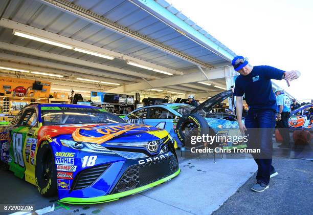 Kyle Busch, driver of the M&M's Caramel Toyota, takes a selfie with his car during practice for the Monster Energy NASCAR Cup Series Can-Am 500 at...