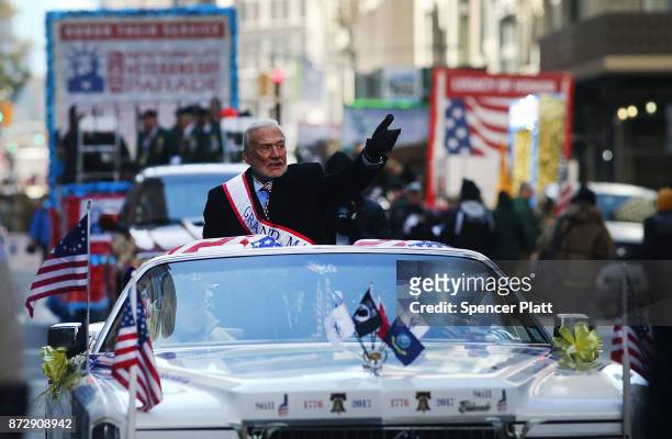 Grand Marshal space pioneer Buzz Aldrin drives up Fifth Avenue in a convertible during the Veterans Day Parade on November 11, 2017 in New York City....