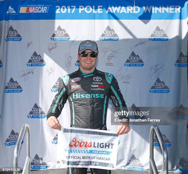 Erik Jones, driver of the Hisense Toyota, poses with the Coors Light Pole Award after qualifying for the NASCAR Xfinity series Ticket Galaxy 200 at...