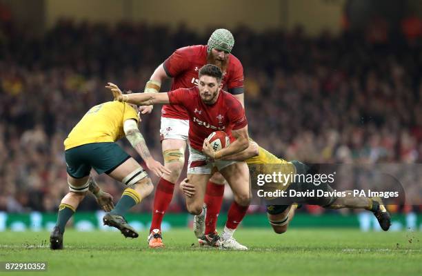 Wales' Owen Williams is tackled by Australia's Sean McMahon and Michael Hooper during the Autumn International at the Principality Stadium, Cardiff.