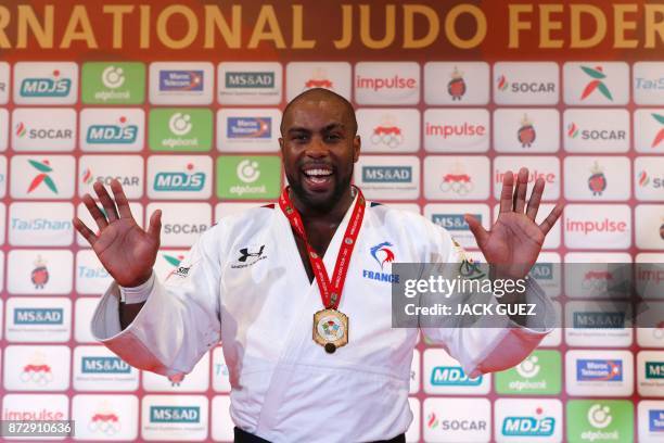 France's gold medallist Teddy Riner gestures as he celebrates on the podium after defeating Belgium's Toma Nikiforov during the Judo World...