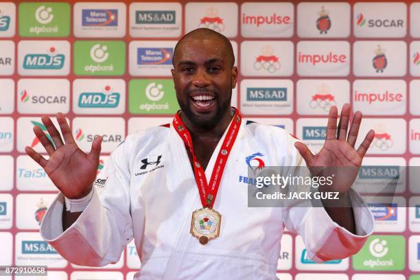 France's gold medallist Teddy Riner gestures as he celebrates on the podium after defeating Belgium's Toma Nikiforov during the Judo World...