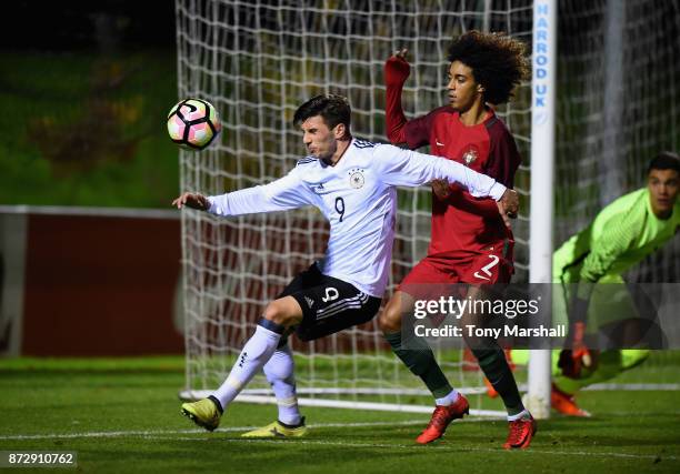 Leon Dajaku of Germany is tackled by Tomas Tavares of Portugal during the International Match between Germany U17 and Portugal U17 at St Georges Park...
