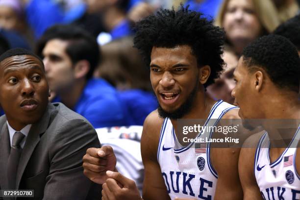 Marvin Bagley III reacts while listening to Trevon Duval as special assistant Nolan Smith of the Duke Blue Devils looks on during their game against...