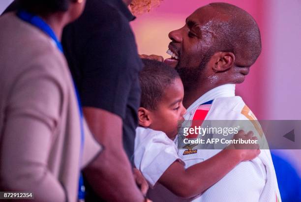 France's gold medallist Teddy Riner celebrates with his family members after defeating Belgian Toma Nikiforov during the Marrakech World Judo...