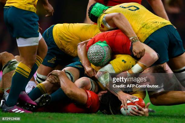 Australia's number 8 Sean McMahon gets tackled during the rugby union international Test match between Wales and Australia at the Principality...