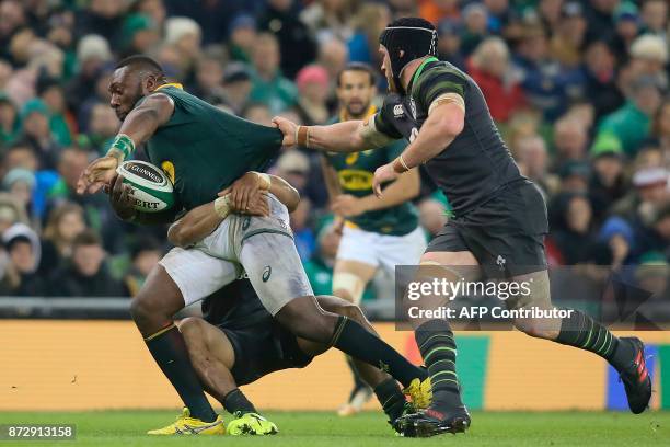 South Africa's prop Tendai Mtawarira is tackled by Ireland's flanker Sean O'Brien during the rugby union international Test match between Ireland and...