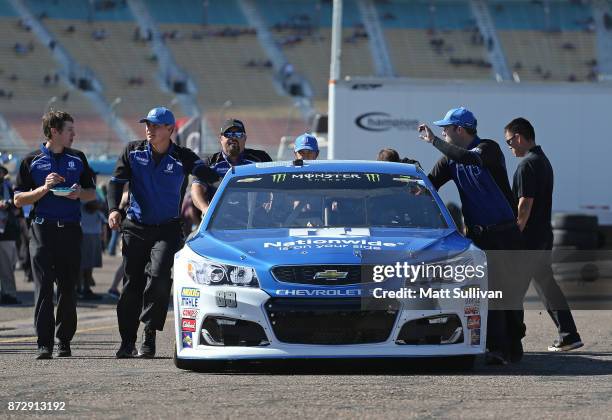 Dale Earnhardt Jr., driver of the Nationwide Chevrolet, has his car pushed through the garage area during practice for the Monster Energy NASCAR Cup...