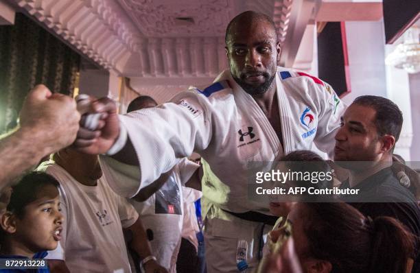 France's gold medallist Teddy Riner celebrates with his fans after defeating Belgian Toma Nikiforov during the Marrakech World Judo Championships...