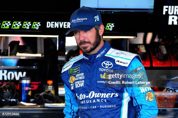 Martin Truex Jr., driver of the Auto-Owners Insurance Toyota, stands by his car during practice for the Monster Energy NASCAR Cup Series Can-Am 500...