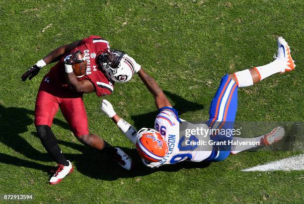 Cece Jefferson of the Florida Gators is called for a facemask penalty as he tackles Mon Denson of the South Carolina Gamecocks during their game at...