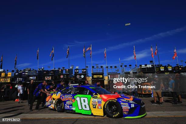 Kyle Busch, driver of the M&M's Caramel Toyota, has his car pushed through the garage area during practice for the Monster Energy NASCAR Cup Series...