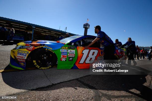 Kyle Busch, driver of the M&M's Caramel Toyota, has his car pushed through the garage area during practice for the Monster Energy NASCAR Cup Series...