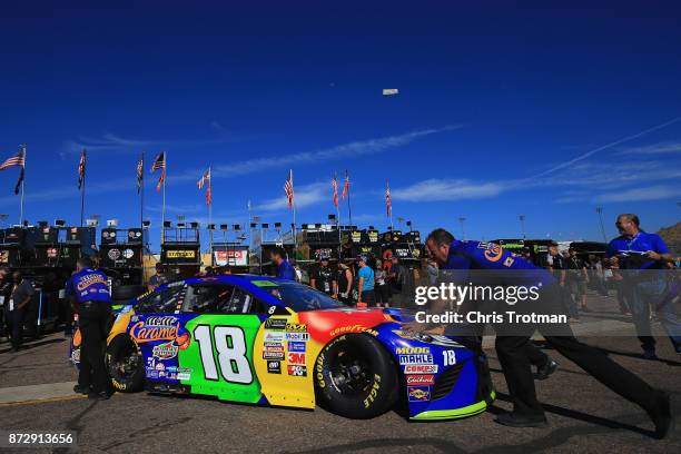 Kyle Busch, driver of the M&M's Caramel Toyota, has his car pushed through the garage area during practice for the Monster Energy NASCAR Cup Series...