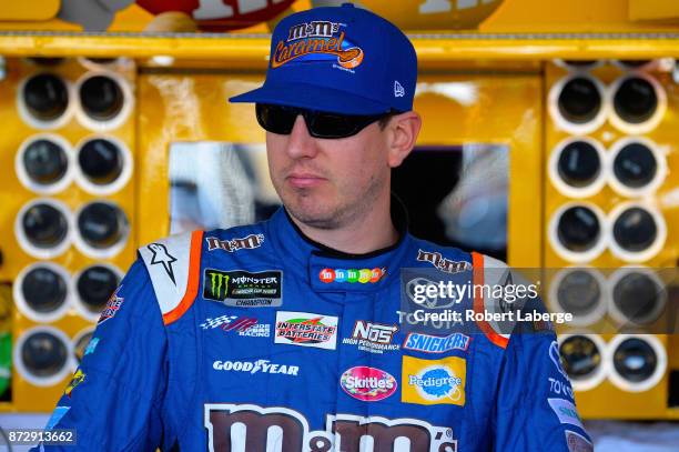 Kyle Busch, driver of the M&M's Caramel Toyota, stands by his car during practice for the Monster Energy NASCAR Cup Series Can-Am 500 at Phoenix...