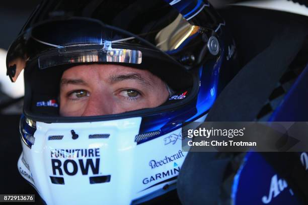 Martin Truex Jr., driver of the Auto-Owners Insurance Toyota, sits in his car during practice for the Monster Energy NASCAR Cup Series Can-Am 500 at...