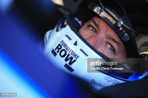 Martin Truex Jr., driver of the Auto-Owners Insurance Toyota, sits in his car during practice for the Monster Energy NASCAR Cup Series Can-Am 500 at...