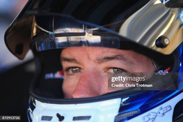 Martin Truex Jr., driver of the Auto-Owners Insurance Toyota, sits in his car during practice for the Monster Energy NASCAR Cup Series Can-Am 500 at...