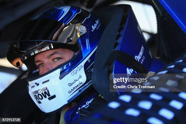 Martin Truex Jr., driver of the Auto-Owners Insurance Toyota, sits in his car during practice for the Monster Energy NASCAR Cup Series Can-Am 500 at...