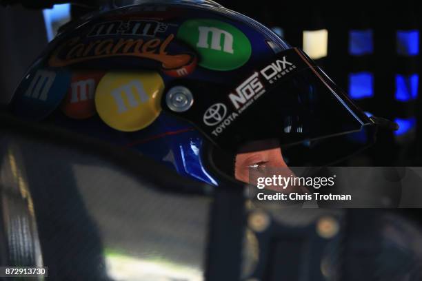 Kyle Busch, driver of the M&M's Caramel Toyota, sits in his car during practice for the Monster Energy NASCAR Cup Series Can-Am 500 at Phoenix...