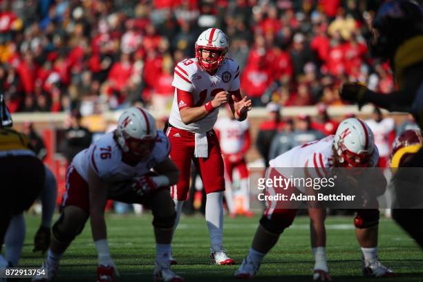 Tanner Lee of the Nebraska Cornhuskers checks the line before the snap against the Minnesota Golden Gophers in the second quarter at TCF Bank Stadium...