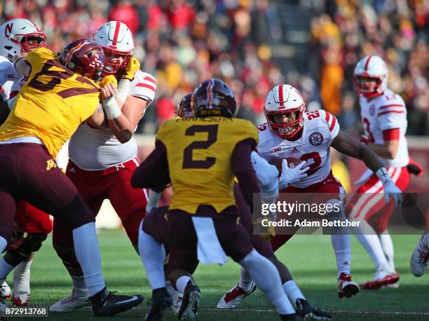 Devine Ozigbo of the Nebraska Cornhuskers carries the ball for a gain in the first quarter against the Minnesota Golden Gophers at TCF Bank Stadium...