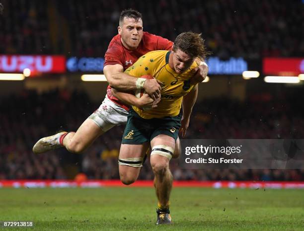 Michael Hooper of Australia dives over to score for the Qantas Wallabies despite the attempted tackle of Gareth Davies of Wales during the...