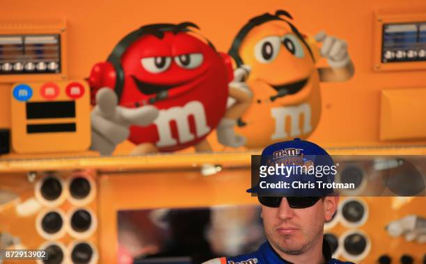 Kyle Busch, driver of the M&M's Caramel Toyota, stands in the garage during practice for the Monster Energy NASCAR Cup Series Can-Am 500 at Phoenix...