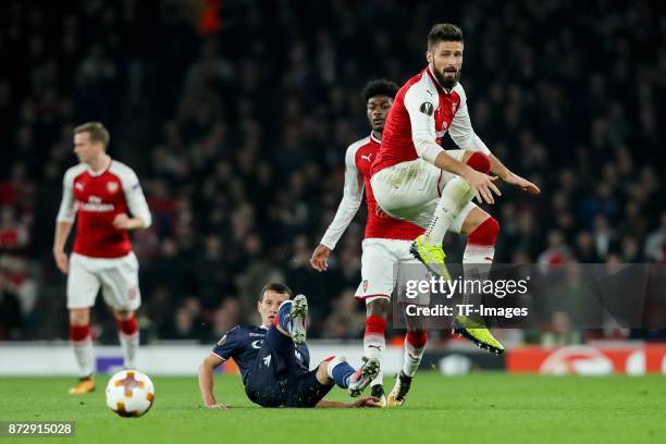 Slavoljub Srnic of Red Star Belgrade and Olivier Giroud of Arsenal battle for the ball during UEFA Europa League Group H match between Arsenal and...