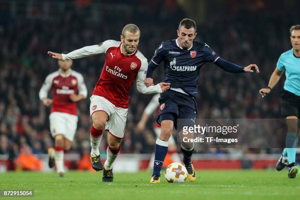 Jack Wilshere of Arsenal and Nenad Krsticic of Red Star Belgrade battle for the ball during UEFA Europa League Group H match between Arsenal and Red...