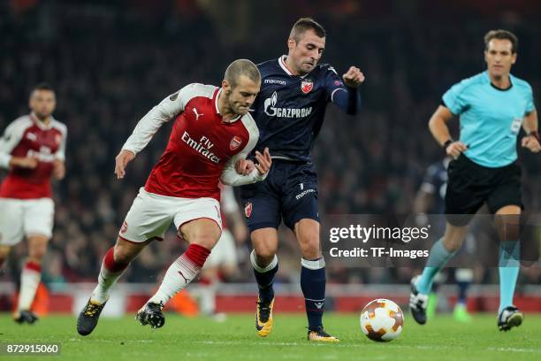 Jack Wilshere of Arsenal and Nenad Krsticic of Red Star Belgrade battle for the ball during UEFA Europa League Group H match between Arsenal and Red...