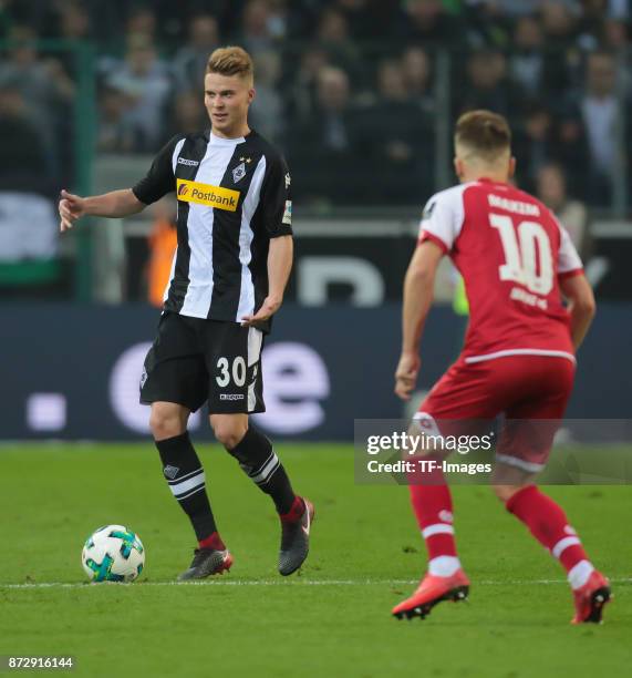 Nico Elvedi of Borussia Moenchengladbach and Alexandru Maxim of FSV Mainz 05 battle for the ball during the Bundesliga match between Borussia...