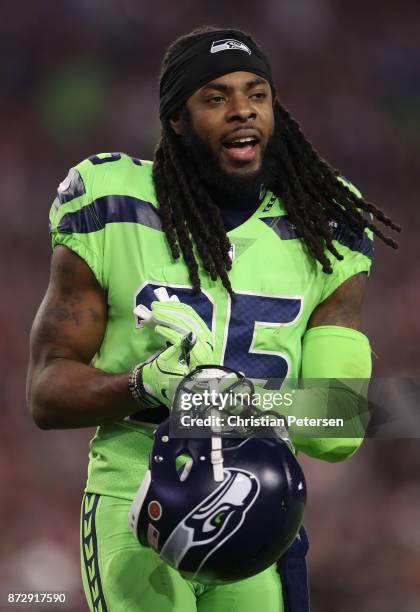 Cornerback Richard Sherman of the Seattle Seahawks walks on the field during a break from the second half of the NFL game against the Arizona...